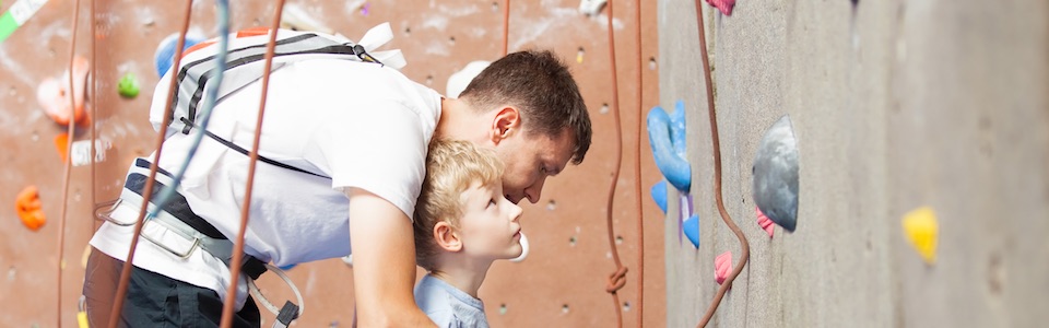 Boy looking at climbing wall