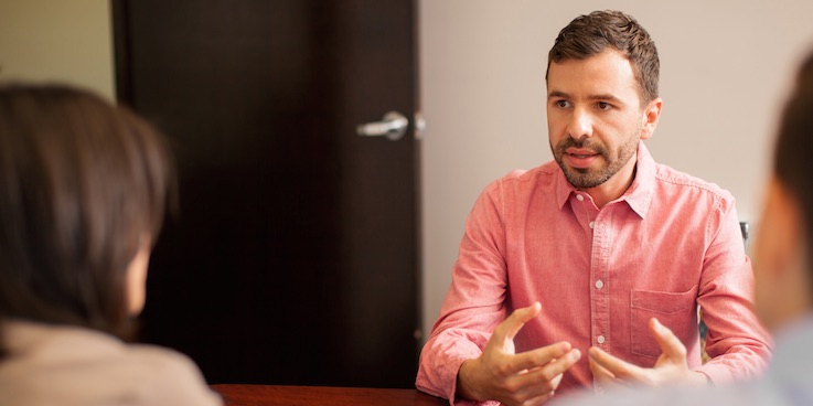 Thumbnail image of people talking around a desk