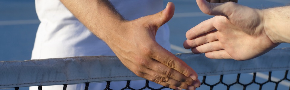 Shaking hands across tennis net