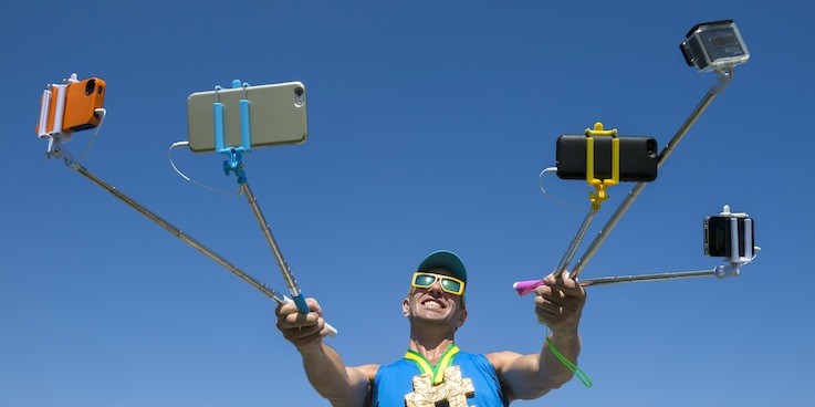 Man holding selfie sticks