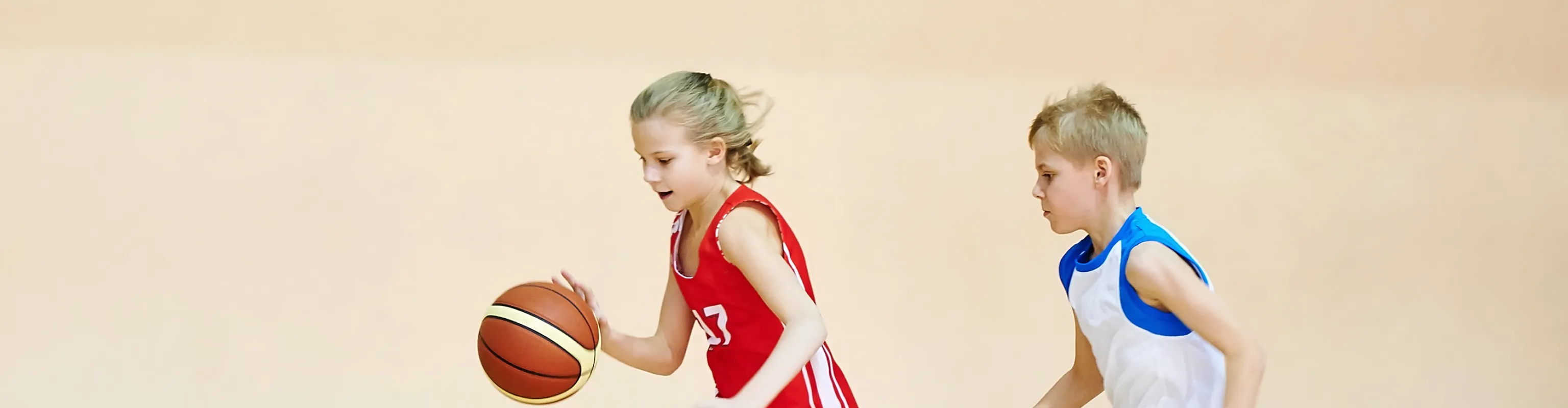 Girl and boy playing basketball