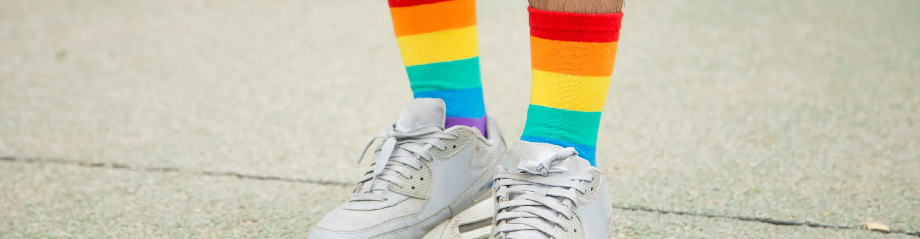 Man in white shoes and rainbow socks