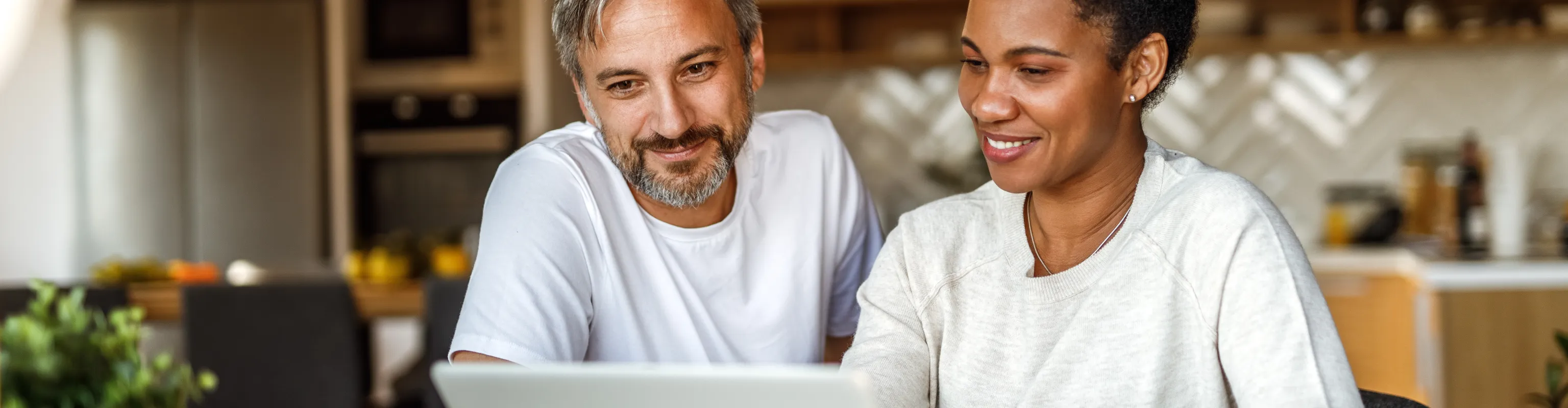 Two adults looking at a laptop