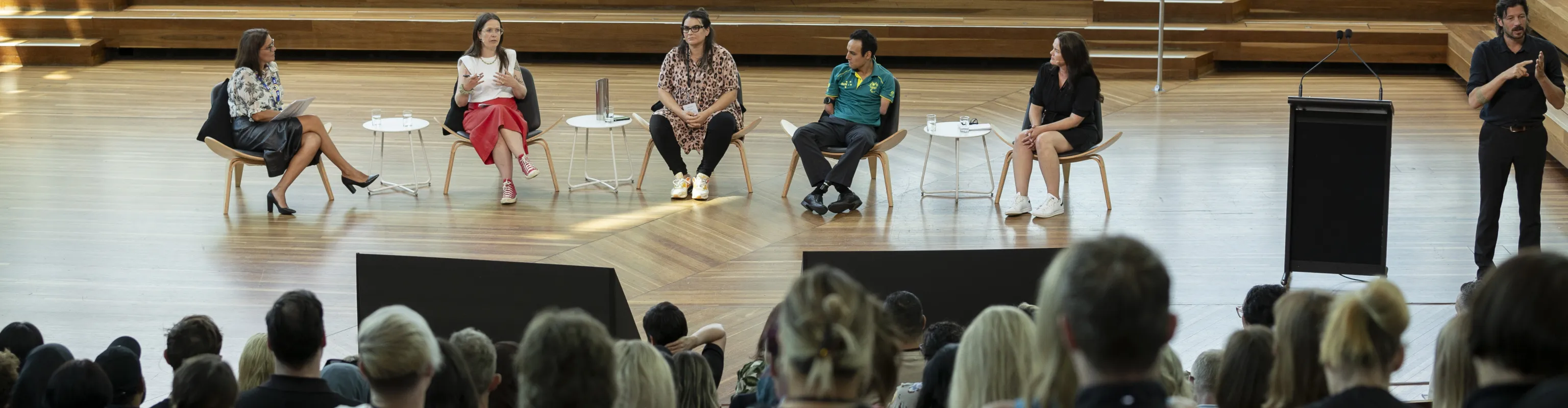 Five people engaged in a panel discussion at the DISA 2024 forum