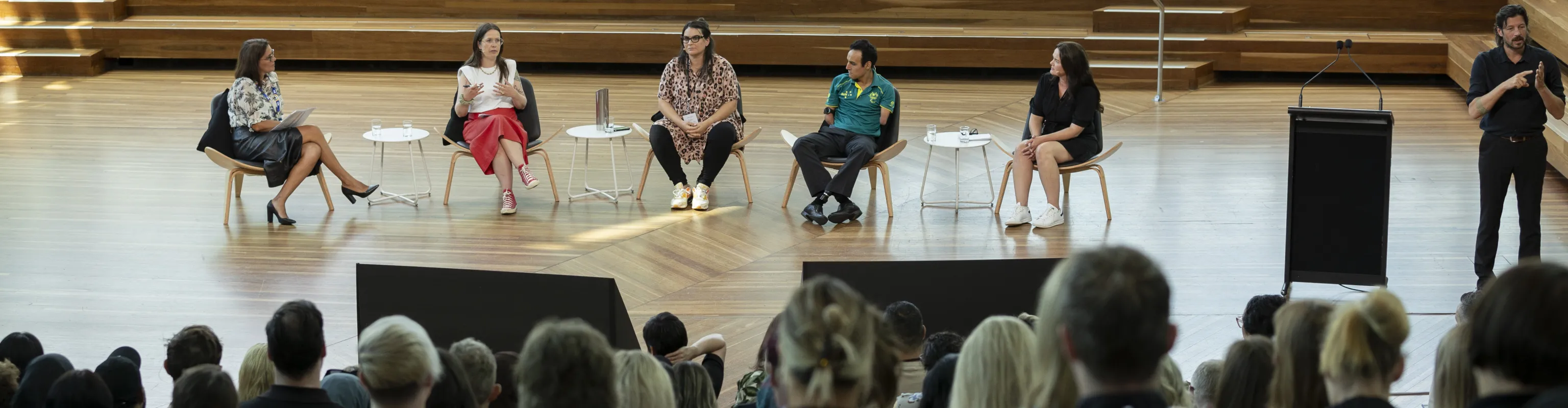 Five people engaged in a panel discussion at the DISA 2024 forum