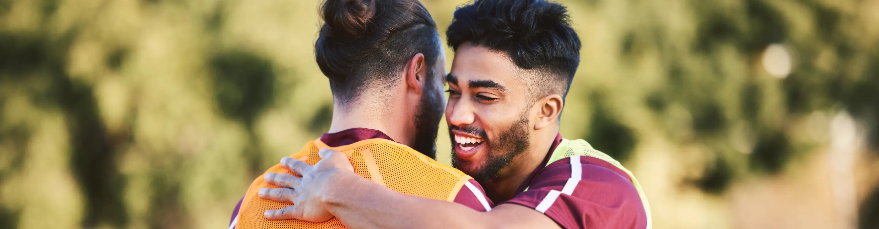 Two men share a hug at rugby training