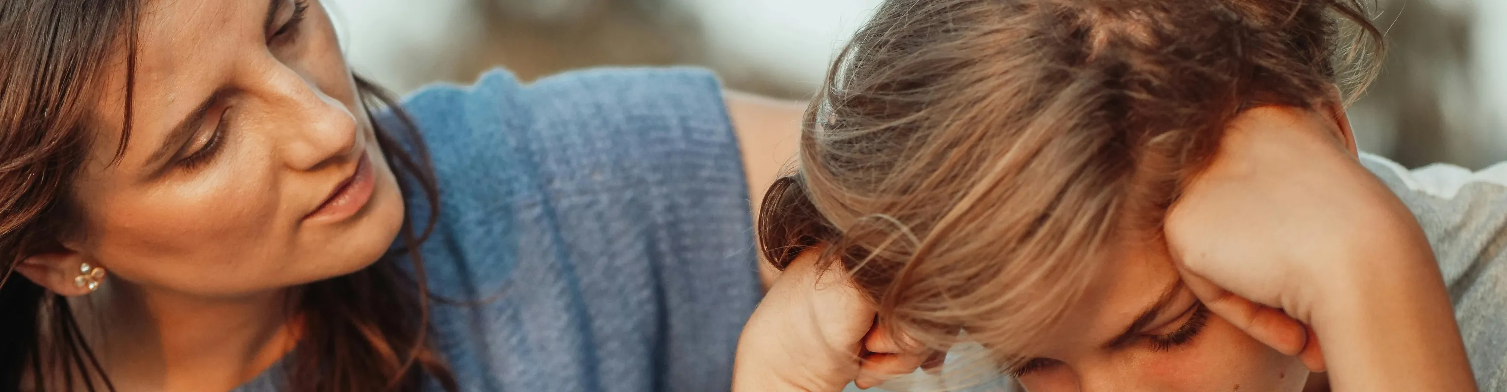 A mother comforts her son in a moment of distress