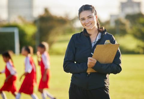 Women with clipboard smiling at the camera