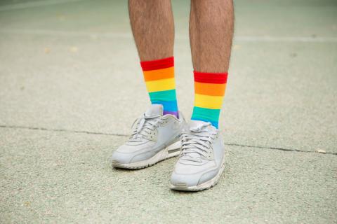 Man in white shoes and rainbow socks