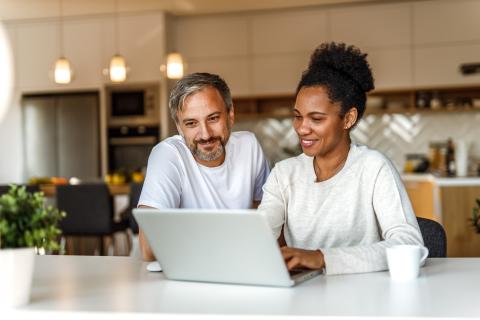 Two adults looking at a laptop