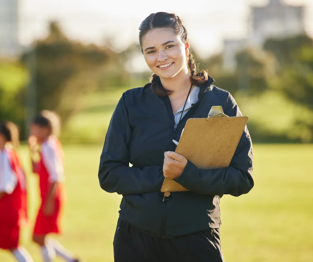 Women with clipboard smiling at the camera