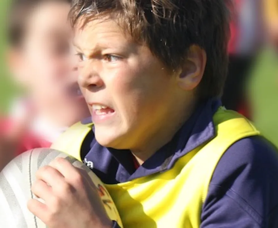 Boy playing rugby