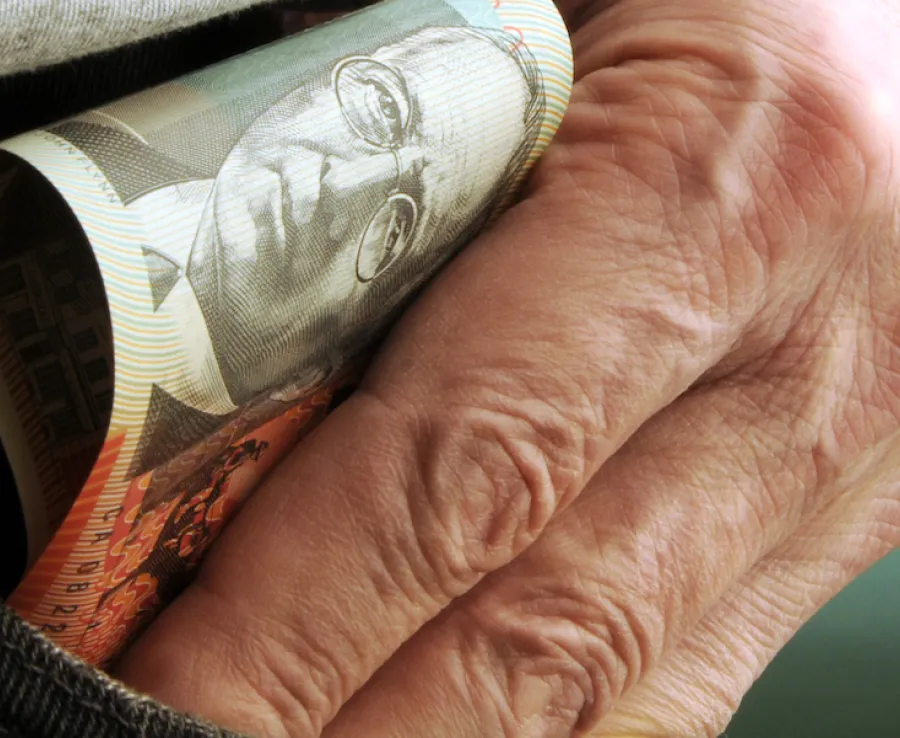 Image of male hand in pocket with money