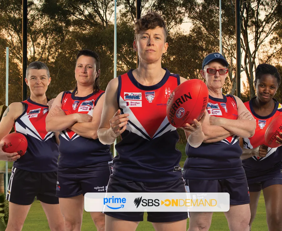 Five people in football clothing staring at the camarea