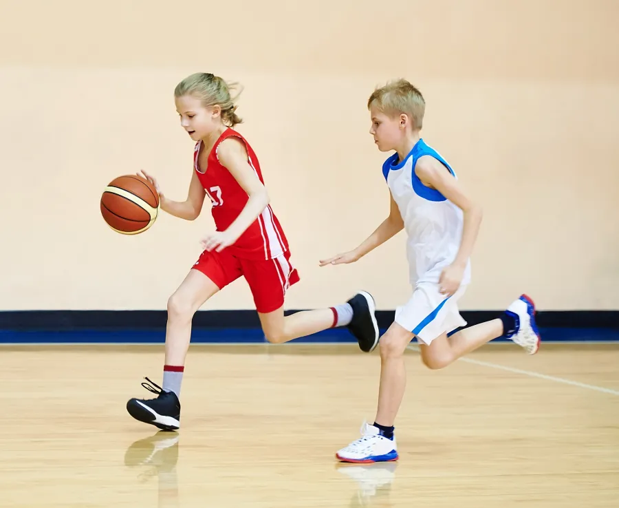 Girl and boy playing basketball