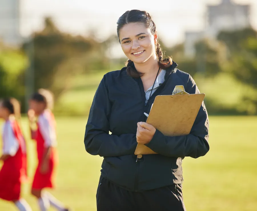 Women with clipboard smiling at the camera