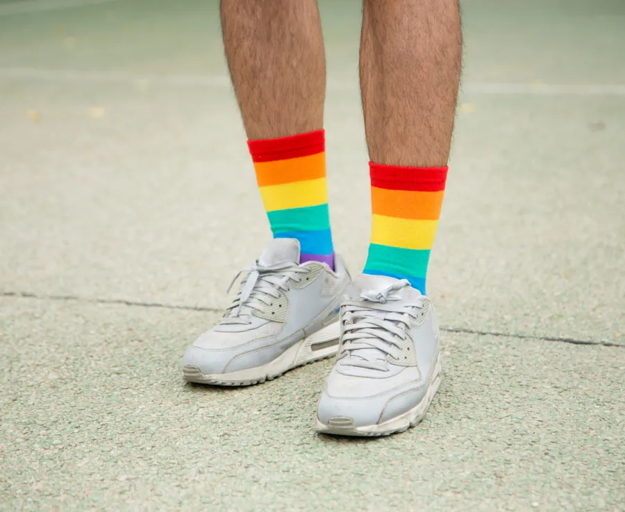 Man in white shoes and rainbow socks