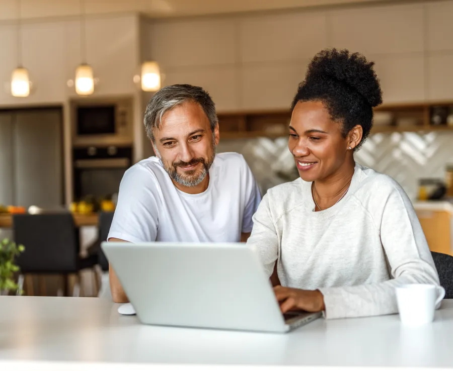Two adults looking at a laptop