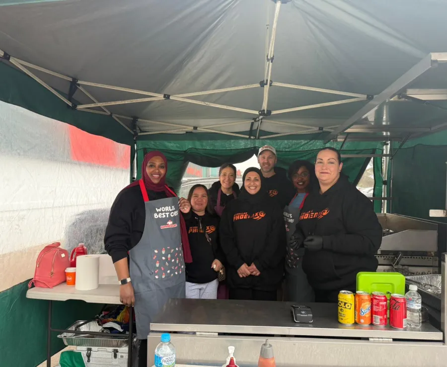 Phoenix Basketball Club members are volunteering at a Bunning sausage sizzle stall to raise funds for the club